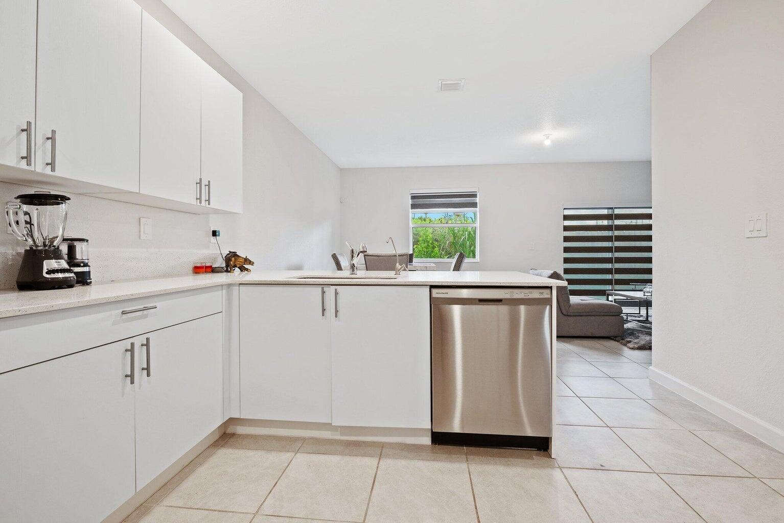 2701 Southeast 10th Street Homestead, FL 33035 - Photo 7 of 23 a kitchen with white cabinets and white appliances