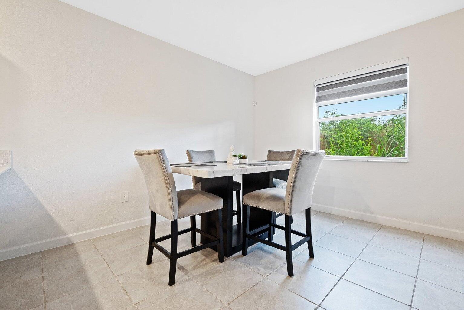 2701 Southeast 10th Street Homestead, FL 33035 - Photo 8 of 23 a view of a dining room with furniture and a window