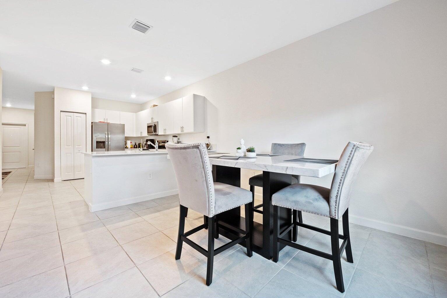 2701 Southeast 10th Street Homestead, FL 33035 - Photo 9 of 23 a dining area with furniture and a kitchen view
