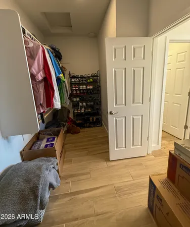 a view of walk in closet with clothes