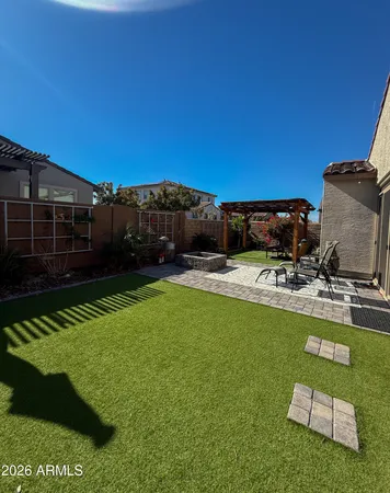 a view of a backyard with swimming pool and furniture