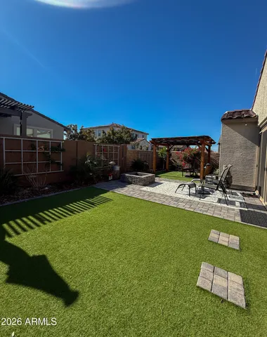 a view of a backyard with swimming pool and furniture