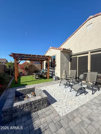 a view of backyard with patio