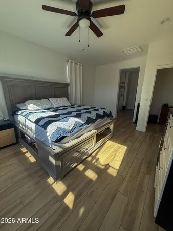 a bed sitting in a bedroom next to a window