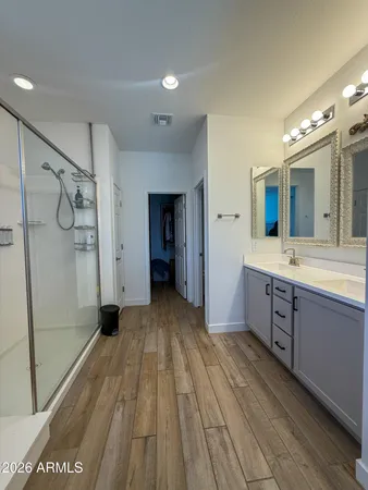 a spacious bathroom with a sink mirror and shower