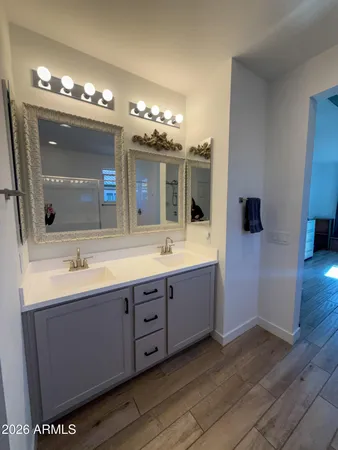 a bathroom with a double vanity sink and a mirror