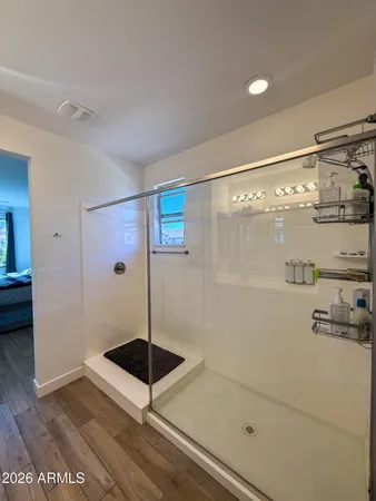 a bathroom with a shower and a sink