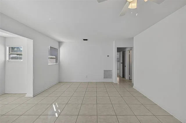 a view of an empty room and a bathroom