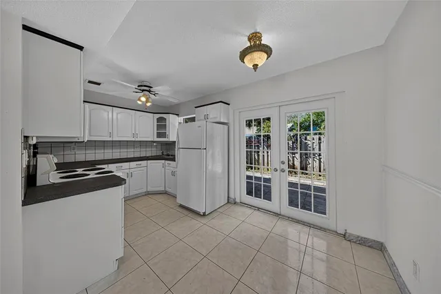 a kitchen with a refrigerator and a stove top oven