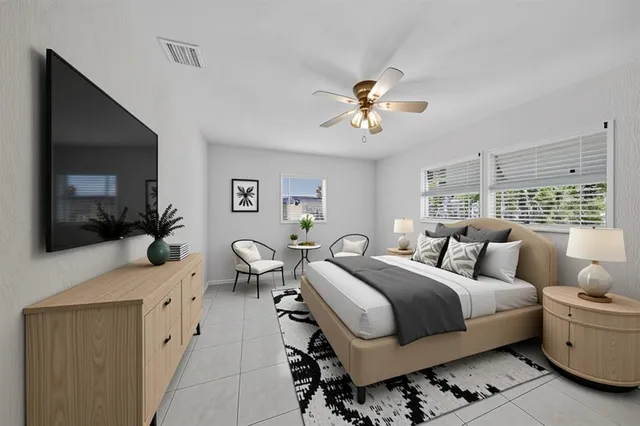 a bedroom with a large bed and a flat screen tv