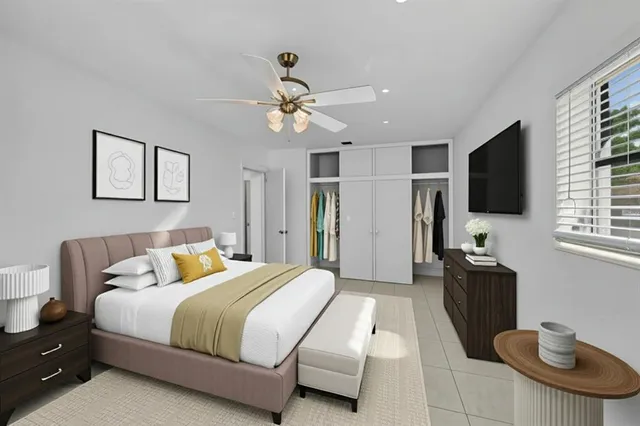 a bedroom with a bed and a flat screen tv