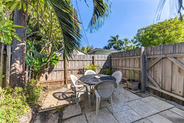 a view of a chairs and table in the backyard
