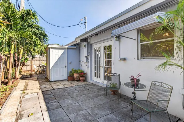 a backyard of a house with outdoor seating