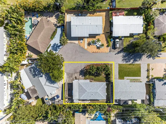 an aerial view of a house with a yard and garden