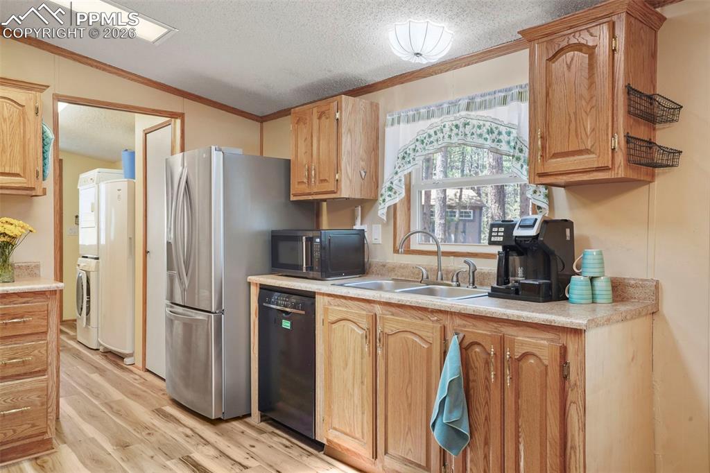2450 Pathfinder Road Florissant, CO 80816 - Photo 11 of 29 a kitchen with stainless steel appliances granite countertop a refrigerator sink and cabinets