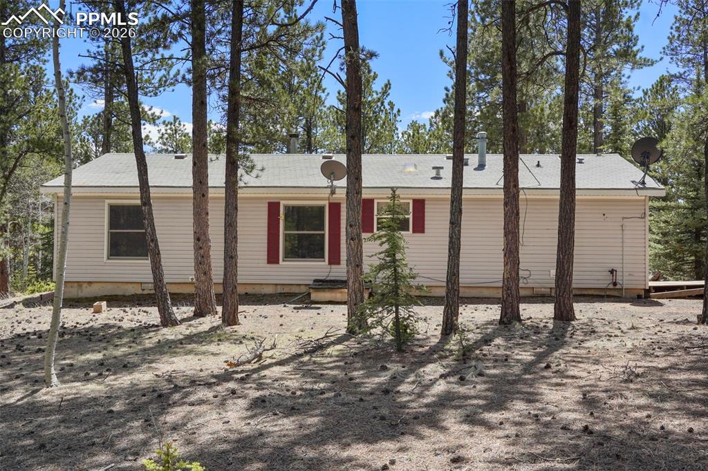 2450 Pathfinder Road Florissant, CO 80816 - Photo 18 of 29 a view of house with backyard and trees