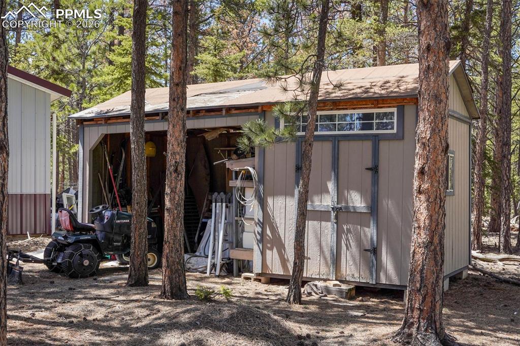 2450 Pathfinder Road Florissant, CO 80816 - Photo 19 of 29 a view of house with utility room and trees