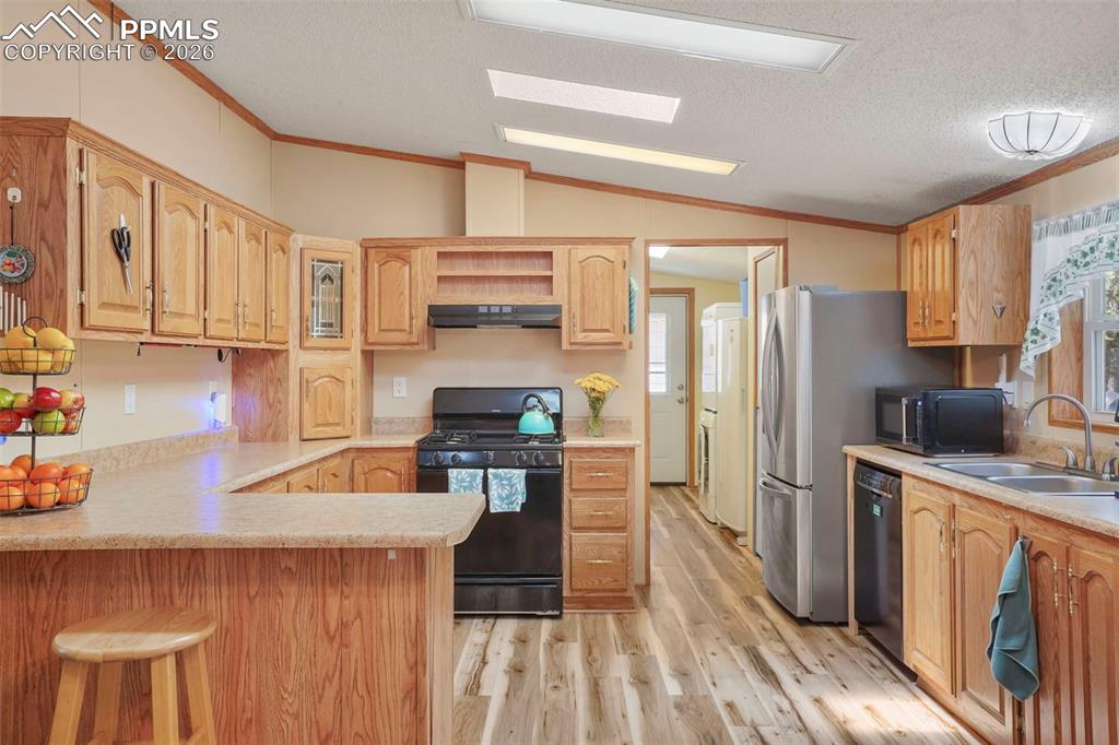 2450 Pathfinder Road Florissant, CO 80816 - Photo 9 of 29 a kitchen with stainless steel appliances a refrigerator a sink a stove and white cabinets