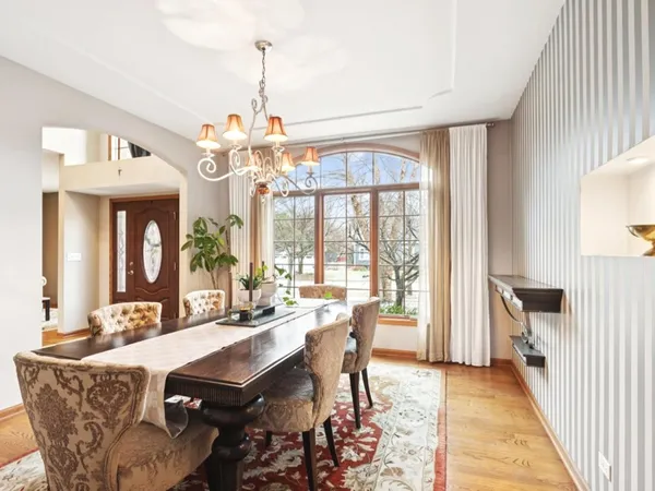 a view of a dining room with furniture wooden floor and a chandelier