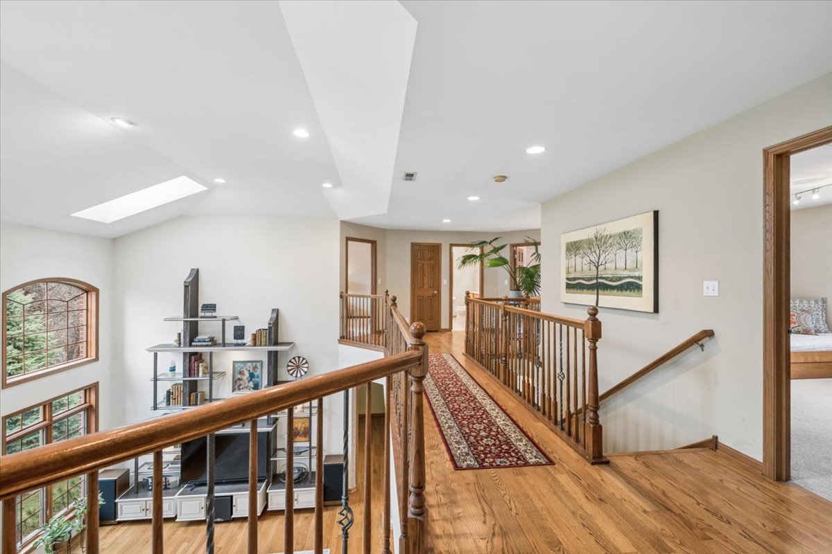 543 Chestnut Street Addison, IL 60101 - Photo 14 of 22 a view of a hallway with wooden floor and stairs