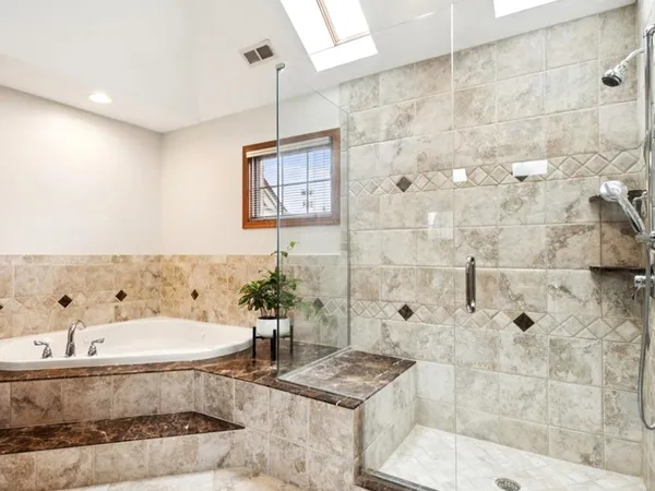 a bathroom with a tub sink and shower