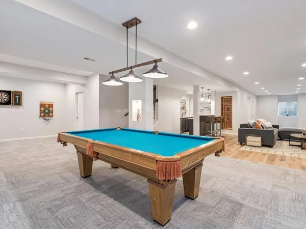 a room with pool table and windows