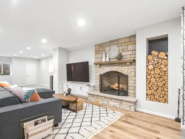 a living room with furniture a fireplace and a flat screen tv