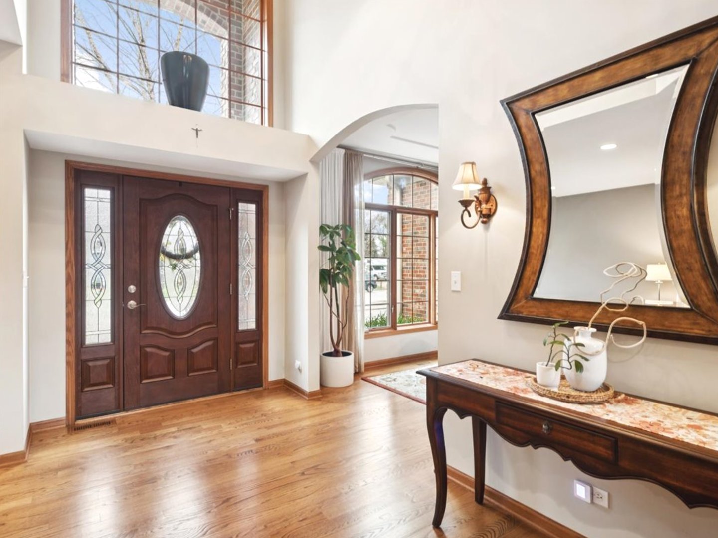 543 Chestnut Street Addison, IL 60101 - Photo 4 of 22 a view of a hallway with wooden floor cabinet and mirror