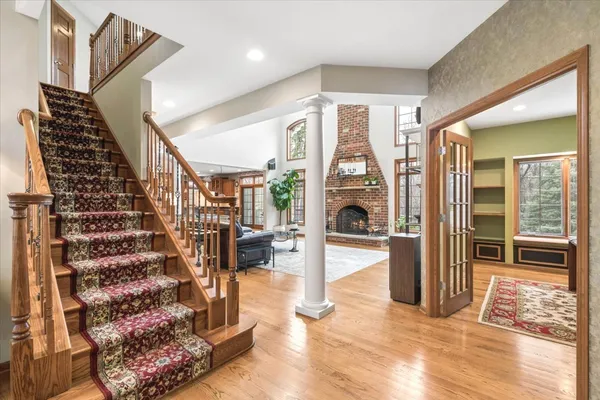 a view of entryway and hall with wooden floor