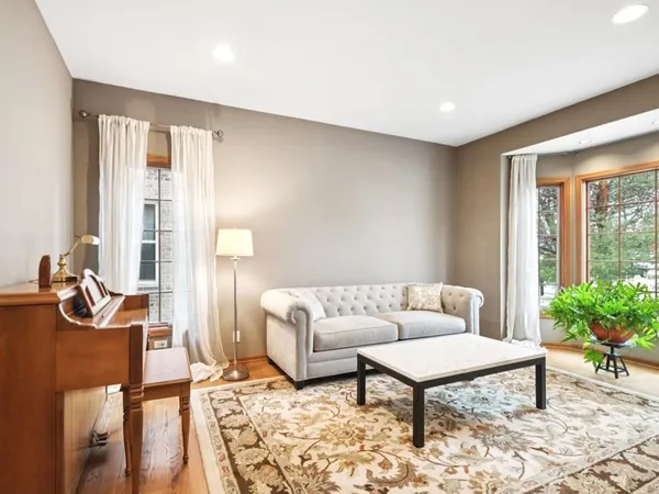 a living room with furniture and a potted plant