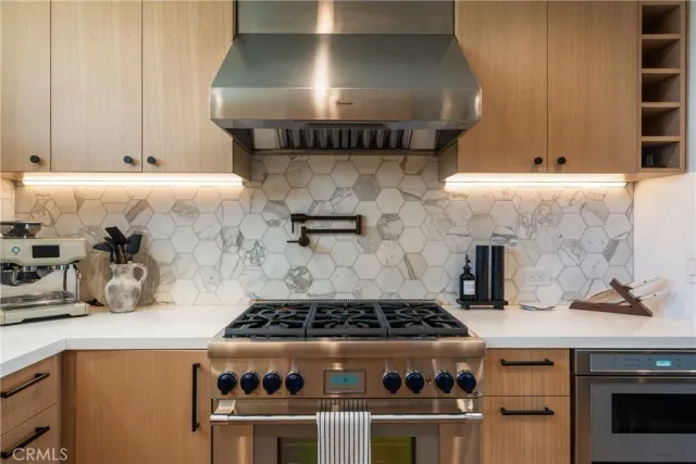 a kitchen with kitchen island white cabinets and refrigerator