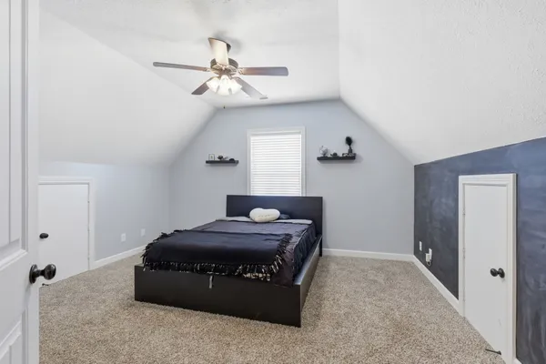 a bedroom with a bed and a chandelier