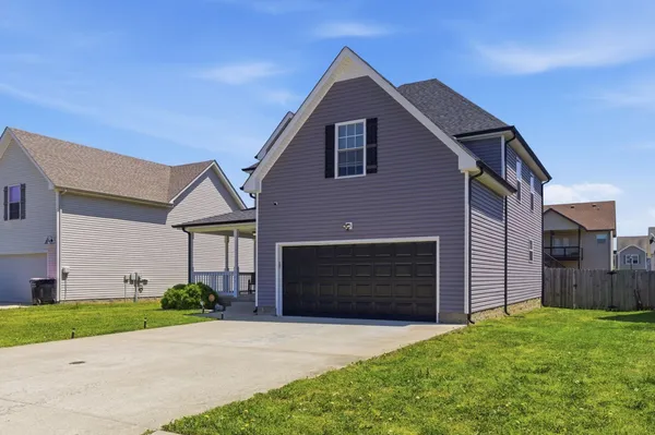 a front view of a house with a yard and garage