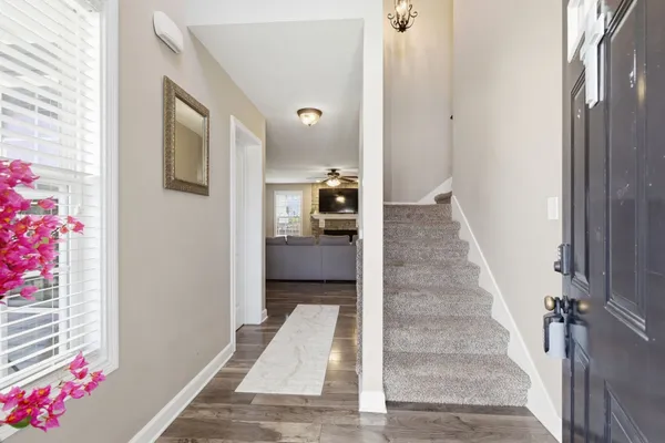 a view of a hallway to a livingroom with furniture