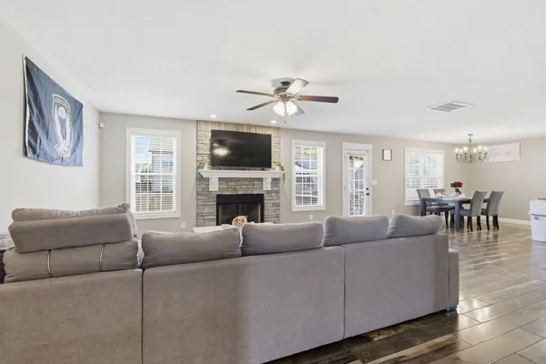 a living room with furniture a fireplace and a flat screen tv