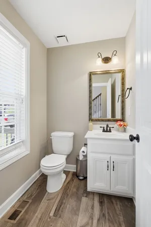 a bathroom with a sink toilet and mirror
