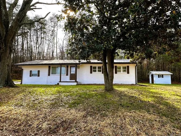 a front view of house with yard and trees
