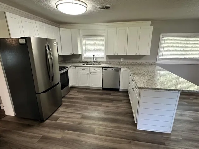 a kitchen with refrigerator and window
