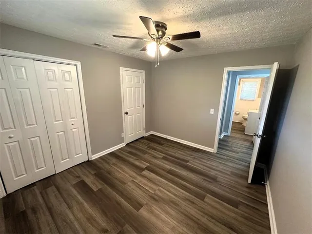 a bathroom with a sink mirror vanity and toilet
