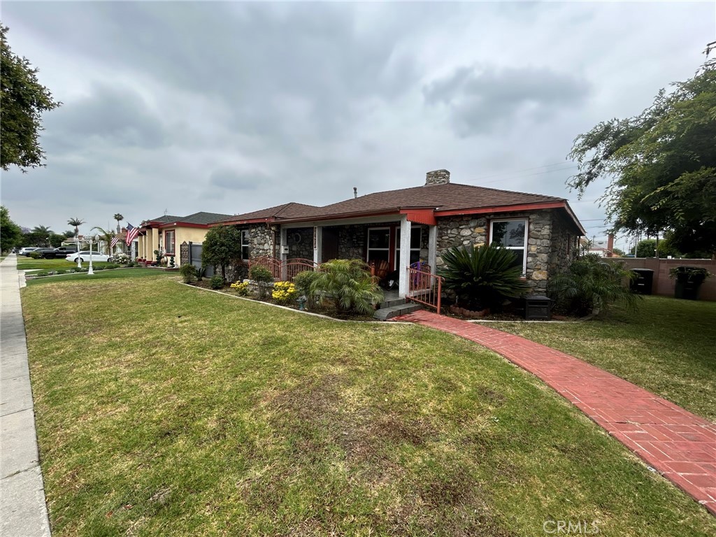 10205 Bryson Avenue South Gate, CA 90280 - Photo 1 of 35 a front view of a house with a garden