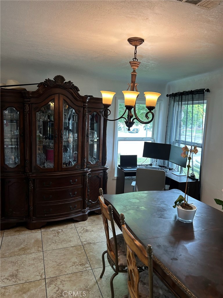10205 Bryson Avenue South Gate, CA 90280 - Photo 11 of 35 a view of a dining room and kitchen with a chandelier