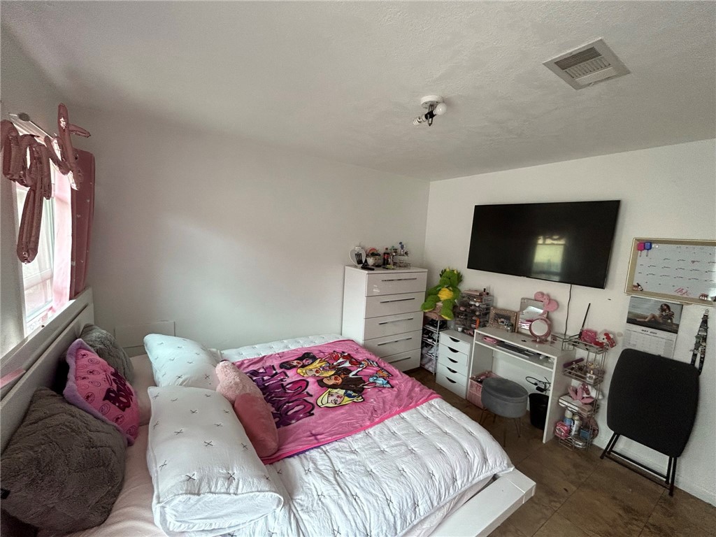 10205 Bryson Avenue South Gate, CA 90280 - Photo 21 of 35 a bedroom with a bed and a flat screen tv
