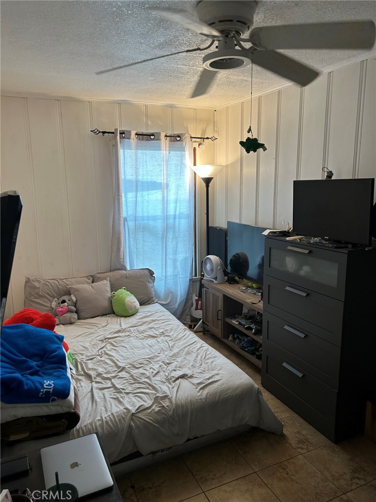 10205 Bryson Avenue South Gate, CA 90280 - Photo 23 of 35 a bedroom with a bed and a chair