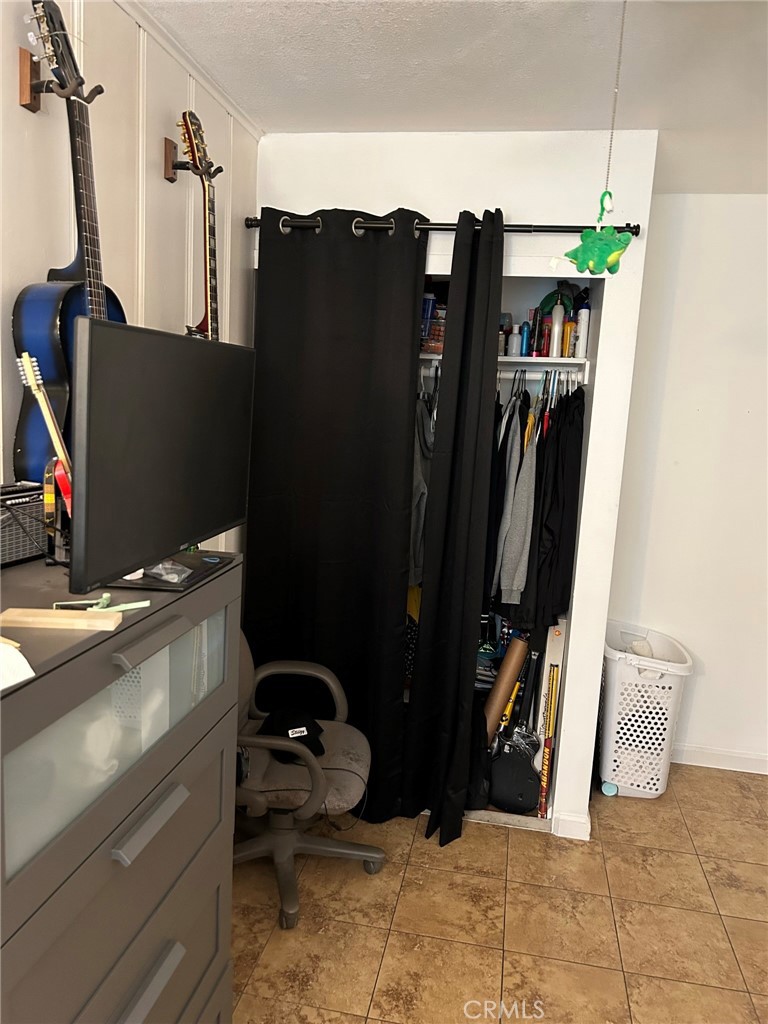 10205 Bryson Avenue South Gate, CA 90280 - Photo 24 of 35 a view of walk in closet with clothes and shoes