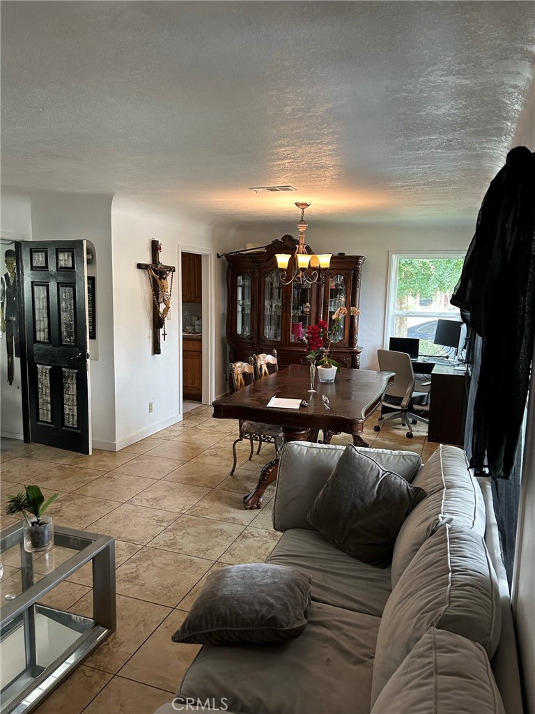 10205 Bryson Avenue South Gate, CA 90280 - Photo 9 of 35 a living room with furniture and a flat screen tv