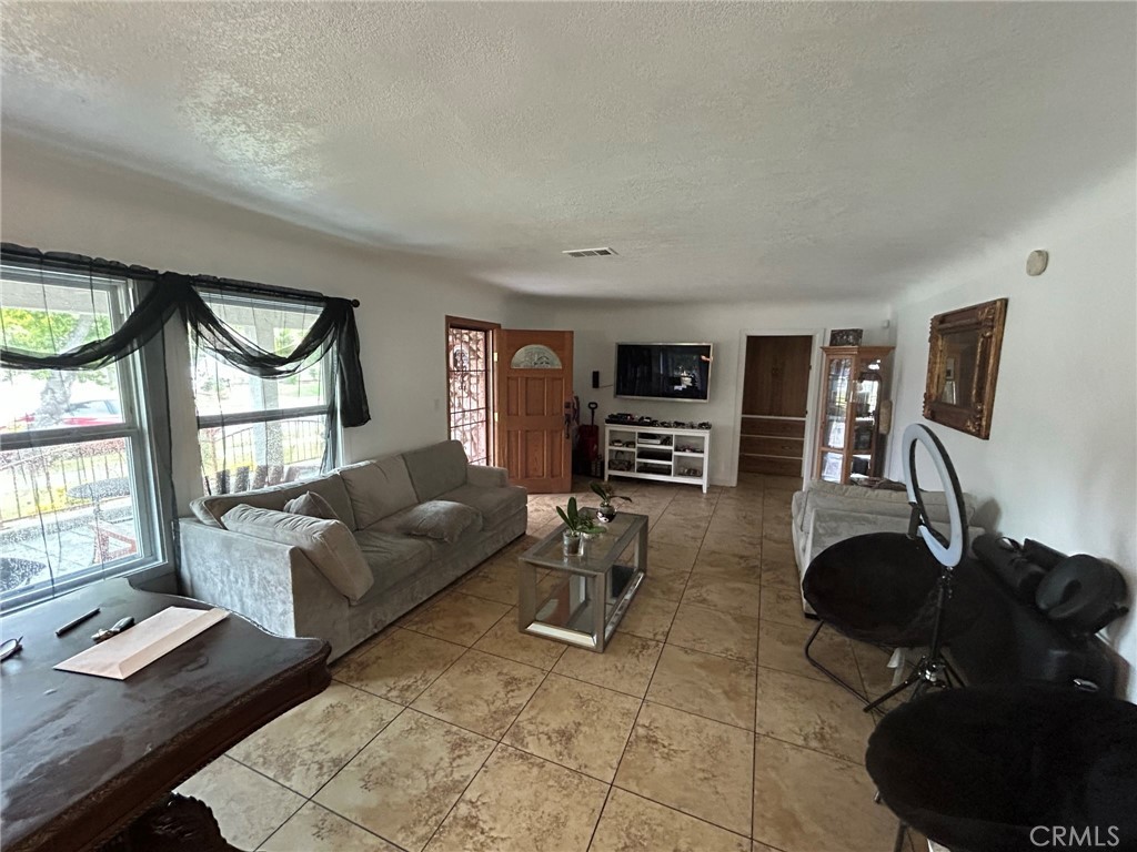 10205 Bryson Avenue South Gate, CA 90280 - Photo 10 of 35 a living room with furniture and a flat screen tv