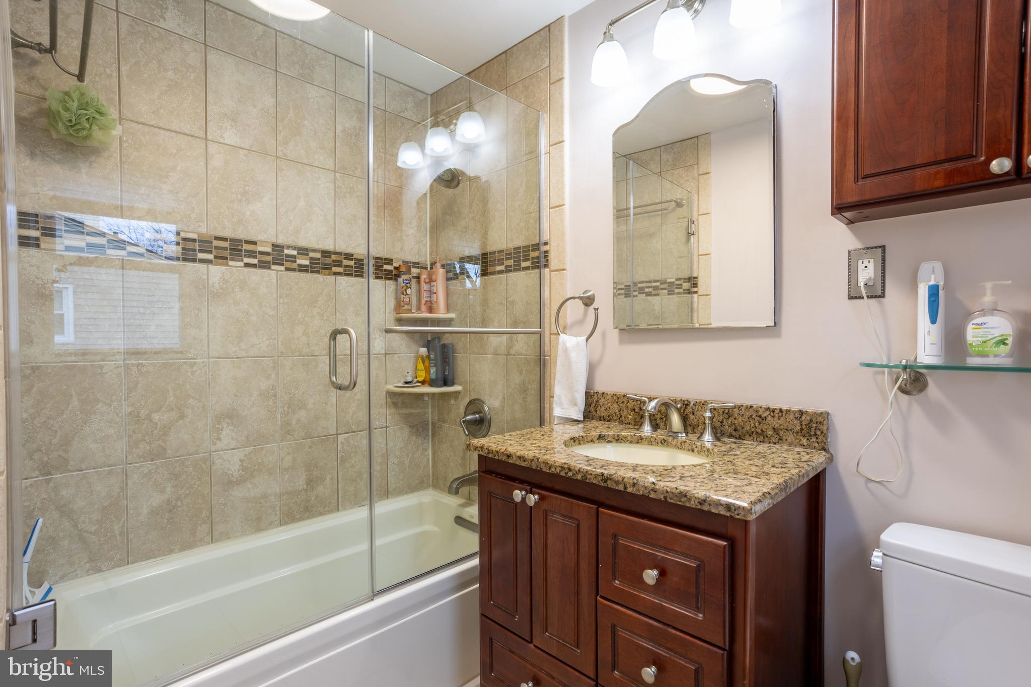 3215 Northbrook Road Baltimore, MD 21208 - Photo 22 of 50 a bathroom with a granite countertop sink toilet and shower