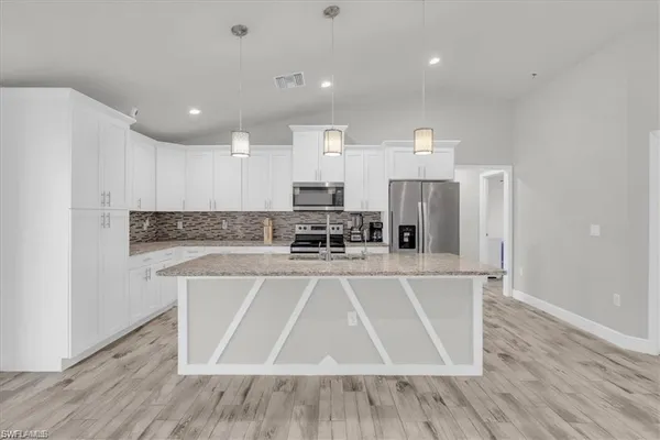 a view of a kitchen with a sink and microwave