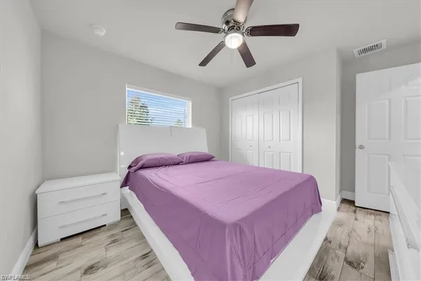 a spacious bedroom with a bed a couch and a window