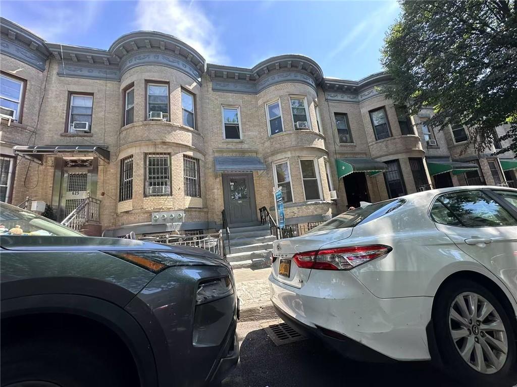 627 50th Street Brooklyn, NY 11220 - Photo 2 of 9 a front view of a house with cars parked
